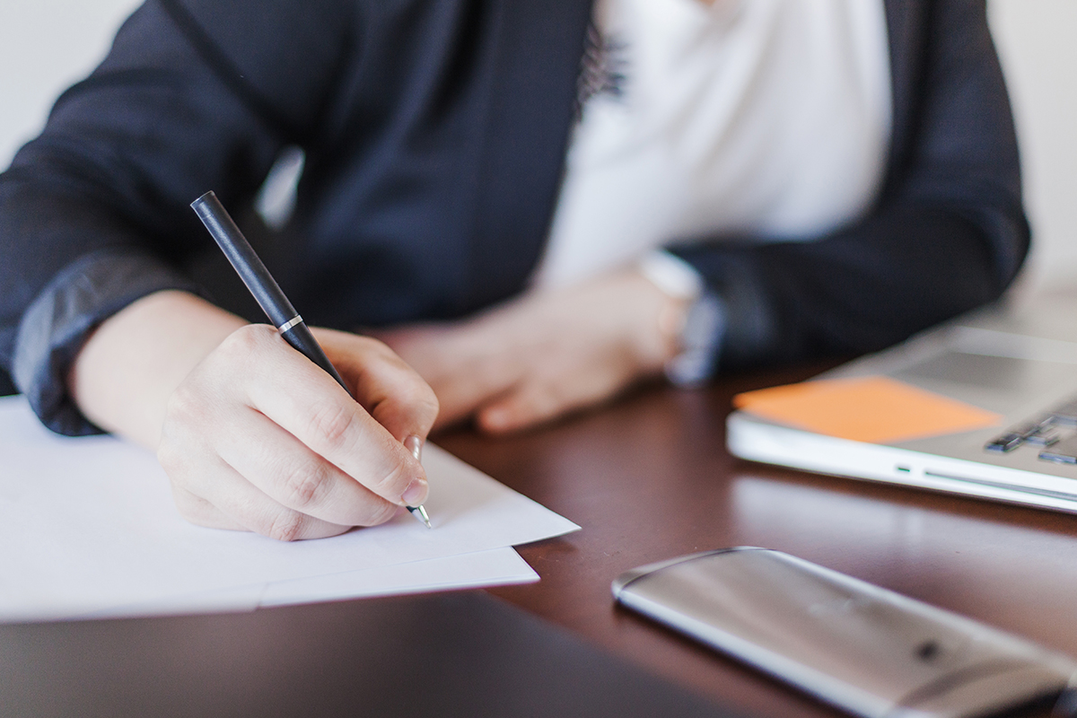 woman-writing-in-office
